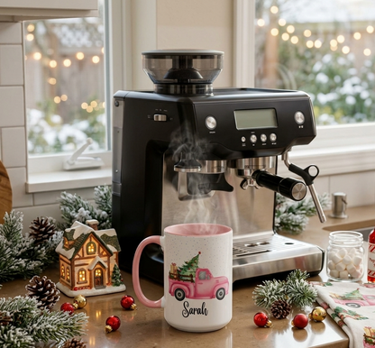 Personalized pink Christmas truck mug with custom name Sarah, featuring a vintage pink pickup carrying a Christmas tree and gifts in a snowy holiday scene.