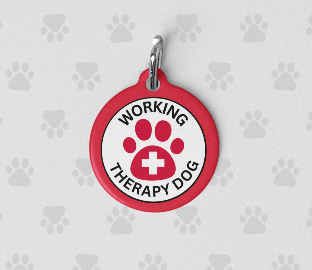 Red personalized Working Therapy Dog ID tag featuring a paw print medical symbol on the front and custom contact information on the back